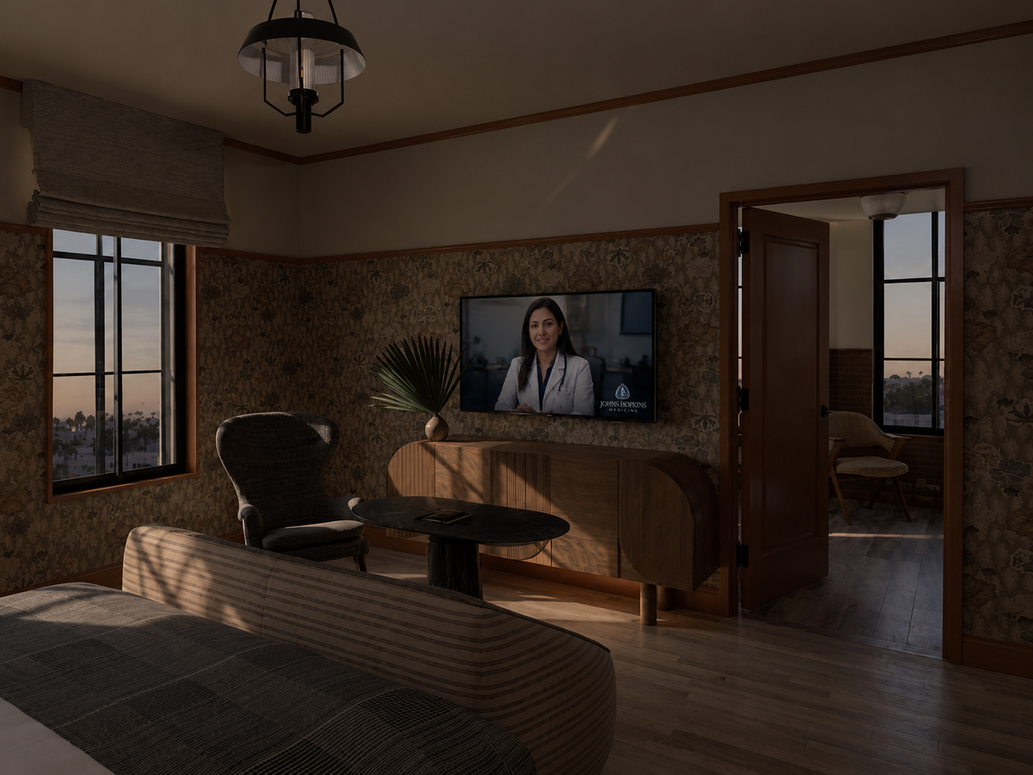 Guest suite at dusk with a Johns Hopkins Medicine sleep specialist on a live telehealth session on the in-room screen